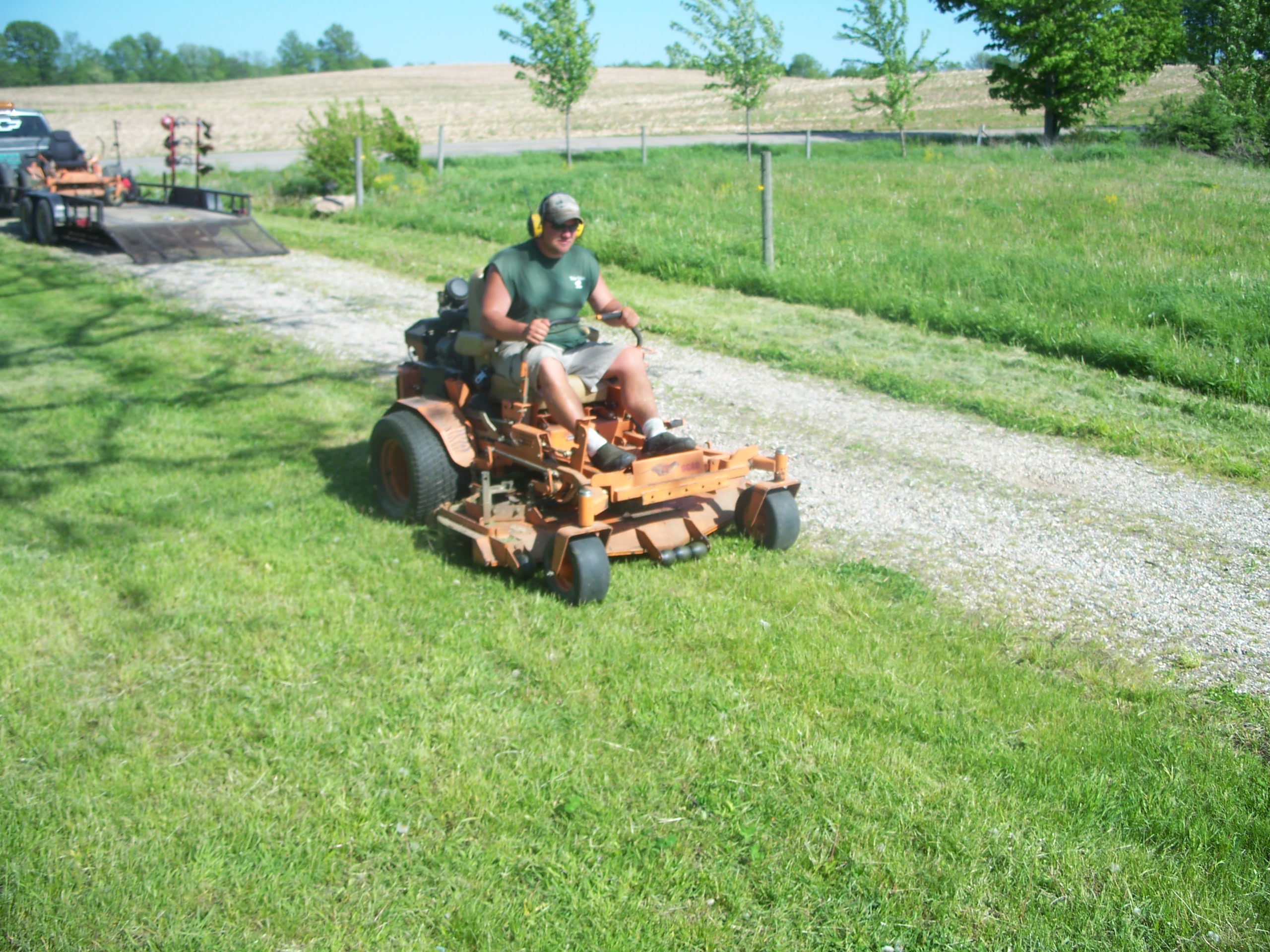 Dan on a Stagg mower performing lawn maintenance